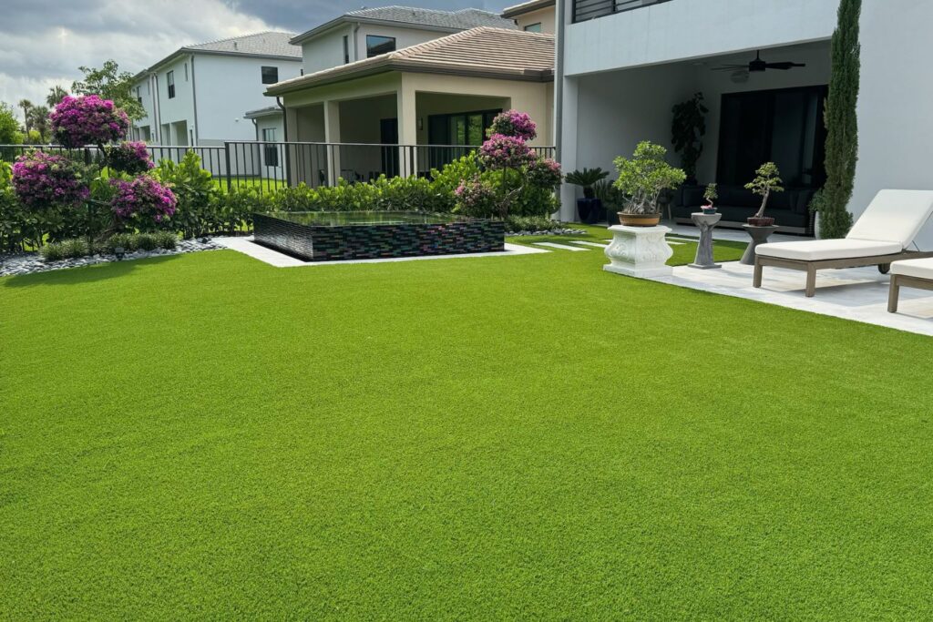 Pet-friendly artificial turf backyard with modern landscaping, patio seating, and low-maintenance synthetic grass.