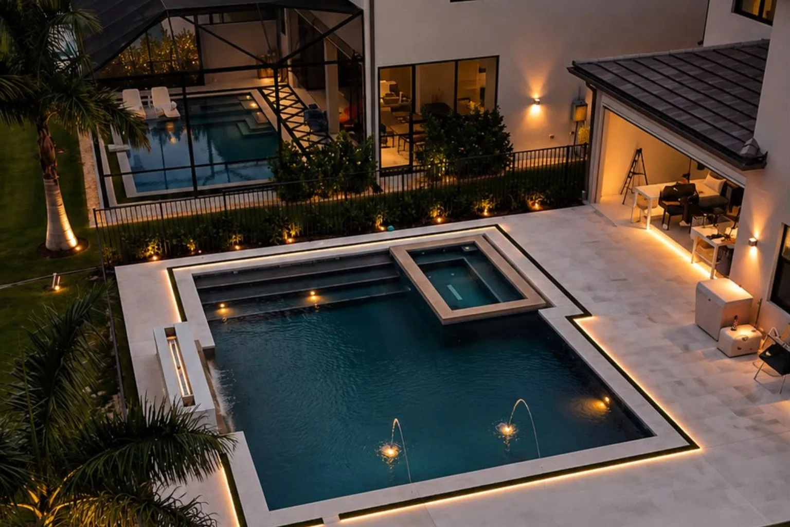 Modern indoor-outdoor patio connecting pool, kitchen, and pergola for a cohesive backyard retreat.